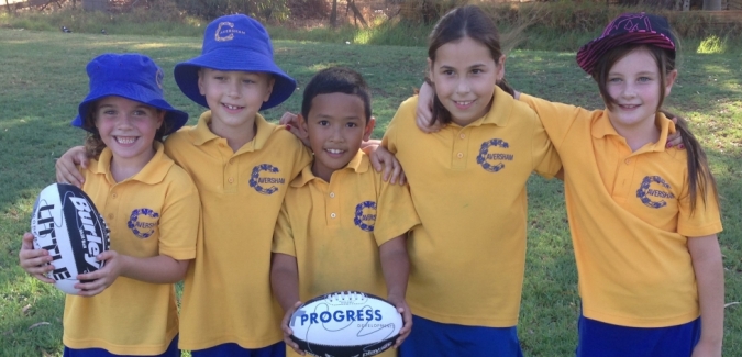 Group of kindy kids take a photo together with footballs